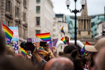 London pride march crowd with rainbow flags