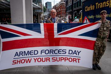 The Lord Mayor is stood behind a Union flag outside City Hall