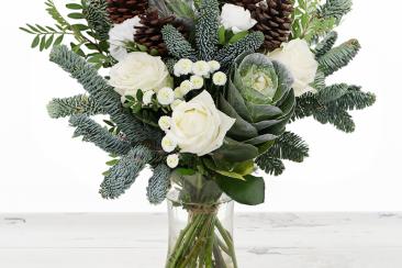 Christmas bouquet with pine cones, white roses and foliage