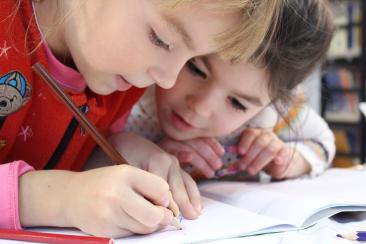 Children drawing with a pencil