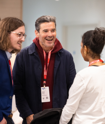 three people talking at an event