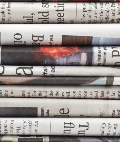 Colour photo of stack of English newspapers 