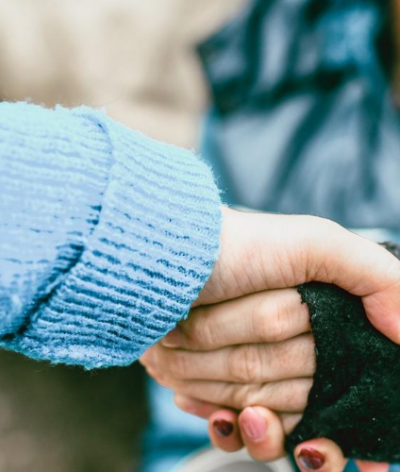 image of a support worker holding out their hand to someone sleeping rough