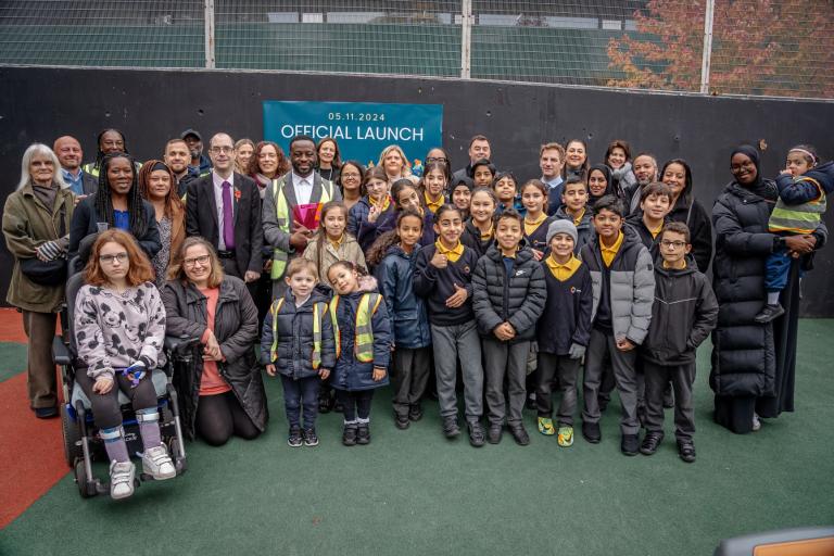 A group photo with children, parents, a local school class and Westminster Council officers and councillors in Alfred Road playground to celebrate the official opening. 