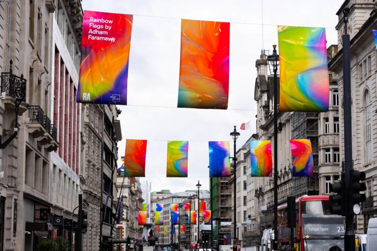 Flags hanging from Piccadilly, the flags are swirls of colour that represent a reimagined LGBT pride flag