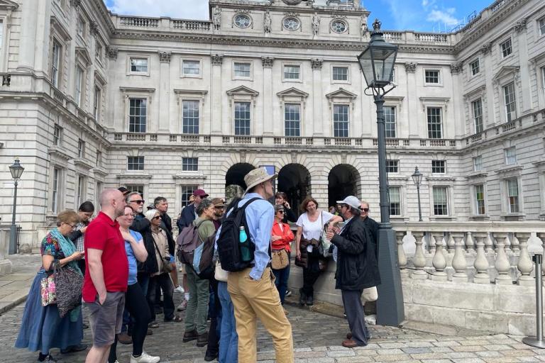 A guide and a group of tourists in the courtyard of somerset house