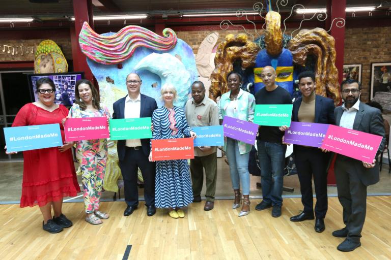 image of a group of people holding banners that say London Made Me