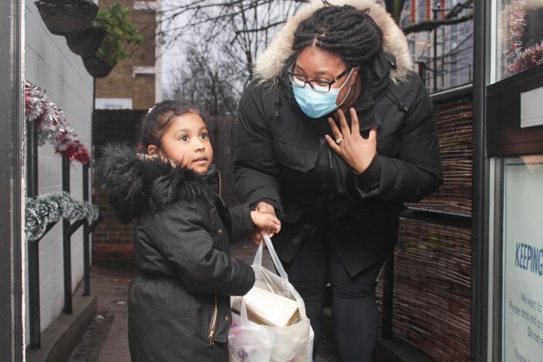 Mother and daughter carrying a shopping bag together.jpg