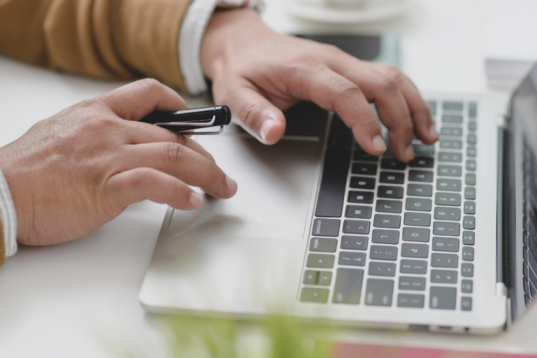 Someone typing on a laptop