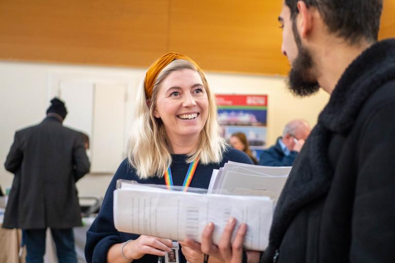 Picture of Westminster Employment Service team employee talking to young man at event