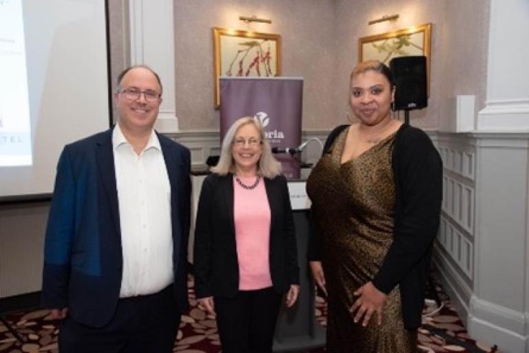 Cllr Adam Hug posing with two business women