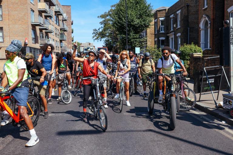 A group of people on bikes cycling through the streets of Westminster