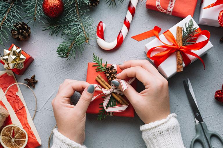 Person wrapping Christmas presents