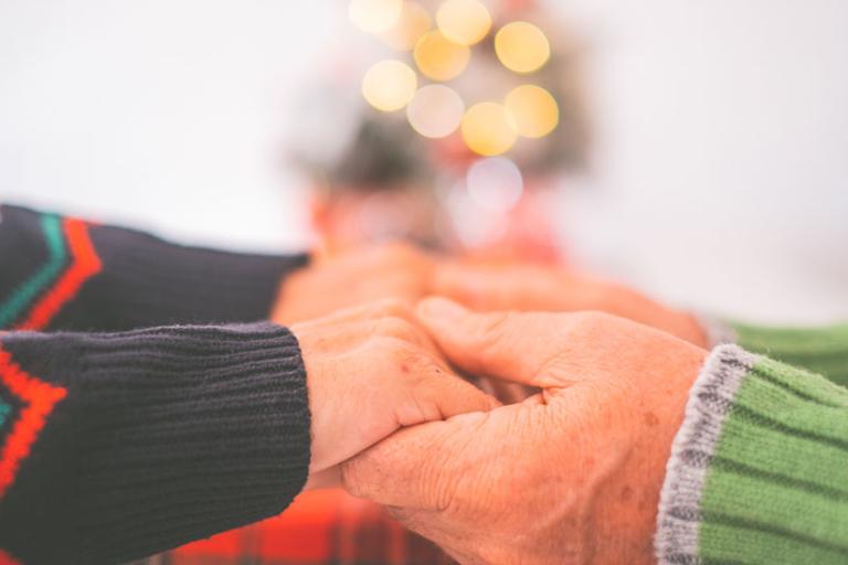 Two people holding hands