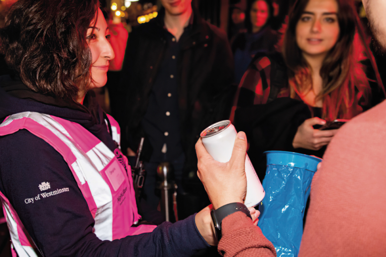 A member of the Night Stars team providing water to a visitor to Westminster