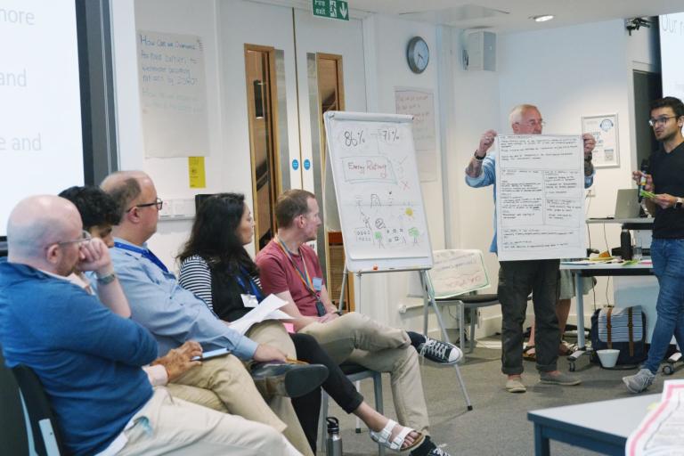 Two climate assembly participants sharing their ideas to councillors and council officers