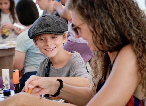 Boy & adult taking part in arts & crafts at Summer on the Square