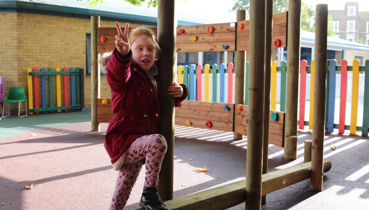 young girl playing in a playground 