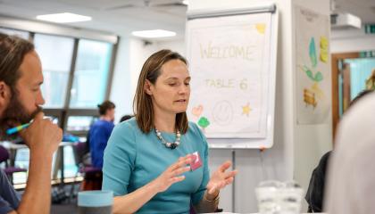 A participant in the climate assembly speaking to their table