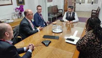 Leader’s visit to Rabbi David Mitchell at the West London Synagogue. Image is of 5 people sat around a table talking.