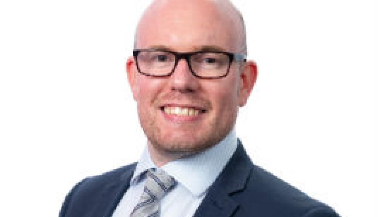 A headshot of Councillor Matt Noble smiling at the camera